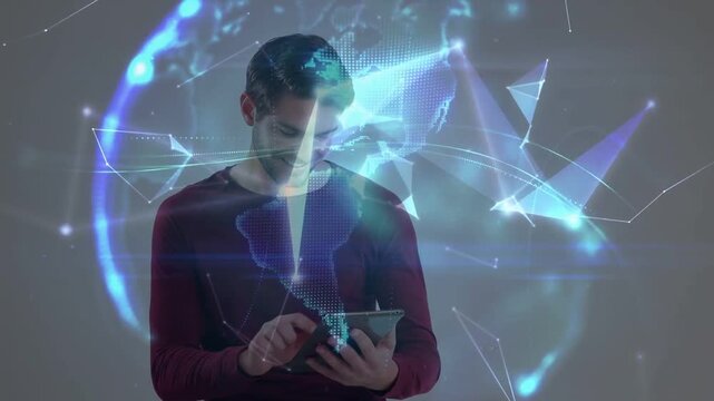 Man tapping tablet in studio initiating tech poly net and showing holo globe forming around him