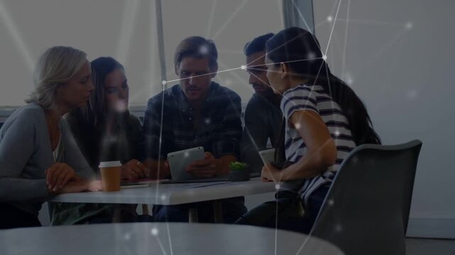 Five biz team leaning around tablet, center man using, causing overlay drifting, reviewing content