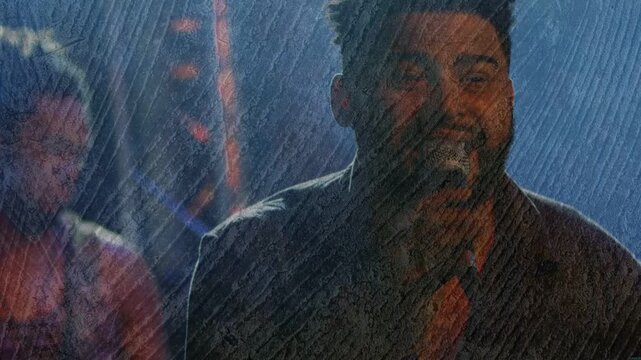Vertical video: Lead singer bringing mic to mouth, singing music onstage, ring overlaying frames