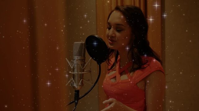 Vertical video: Singer reading cue card, singing into mic in studio, starry overlay sparkling above