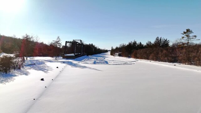 The Historic Canadian National Railway Swing Bridge Over Trent Severn Waterway in Frankford Ontario Canada, Low Aerial Drone Shot.