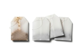 A collection of four white paper tea bags displayed on a clean and isolated plain white background