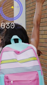 Vertical video: Girl pastel pink or aqua backpack walking celebrating updating StockLimit gauge edu