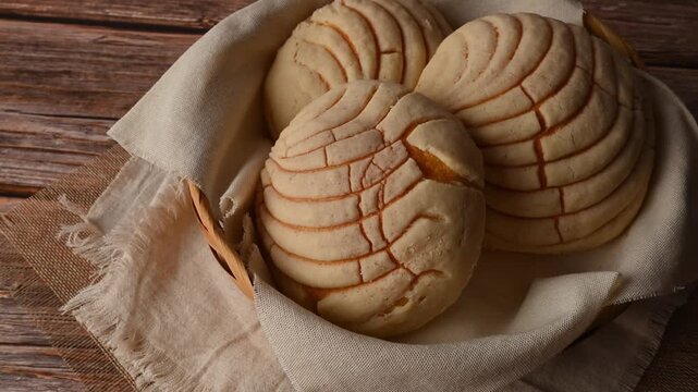 Low key of traditional Mexican sweet bread Conchas in a basket, aerial view
