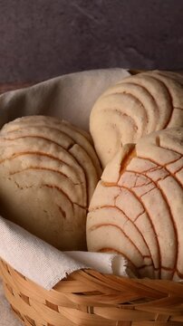Low key video of authentic vanilla conchas Mexican pastry on a rustic wooden background