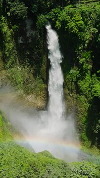 Waterfalls over the rainbow with beautiful water splashing and making mist. Lake Sebu, South Cotabato. Mindanao, Philippines. Vertical view.