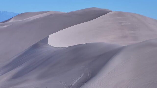 Telephoto Aerial Pan Revealing Snow-Capped Mountain Big Dune NV