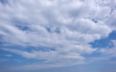 Fototapeta premium clear blue sky background,clouds with background, Blue sky background with tiny clouds. White fluffy clouds in the blue sky. Captivating stock photo featuring the mesmerizing beauty of the sky and cl