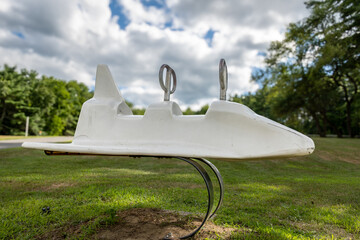 Old, retro, used plastic park playground spring space shuttle, rocker, rocking, equipment at a park, school. 