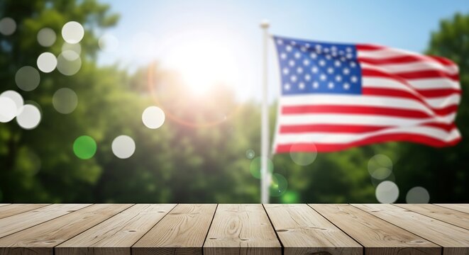 An empty wooden table surface displayed with a blurred american flag in the sunny background scene