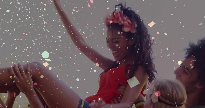 Group bracketing legs and lifting then lowering woman in red, confetti overlaying for event promo