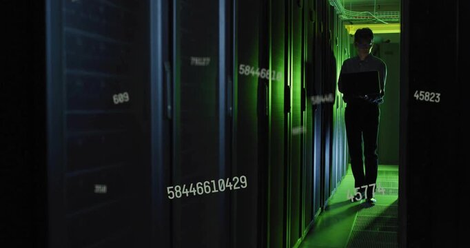 Tech entering server row with laptop moving while checking servers numbers flowing in front of Tech