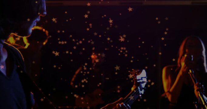 Vertical video: Riff starting singer leaning mic player reaching stars filling frame raising music