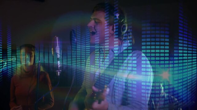 Vertical video: Male singer adjusting grip, strumming, singing in studio for duet EQ overlay moving