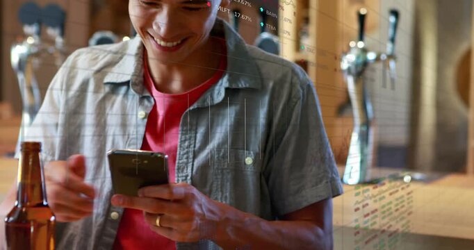 Vertical video: Man at bar framing nachos with phone rotating checking screen charts overlaying ads