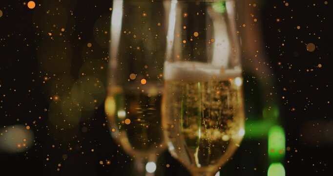 Vertical video: Champagne flutes framing, focus pulling, bubbles rising, sparks drifting for event