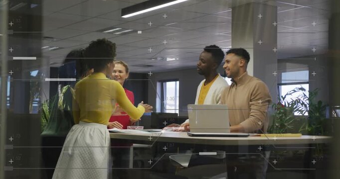 Office team gathering around table woman in yellow initiating hand stack over laptop for teamwork