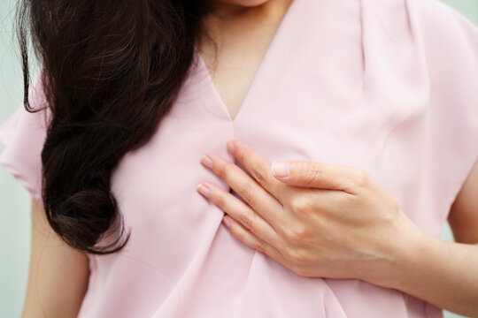 Asian woman self touching check lump or Breast cancer, Breast Self Exam.