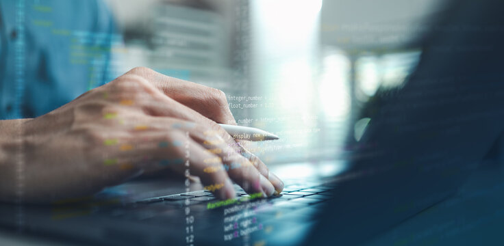 Software developer writing programming code on laptop with digital data interface, representing software development, coding process, artificial intelligence technology and engineering.