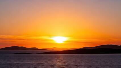 Obraz premium A serene sunset over a calm body of water with mountains in the distance