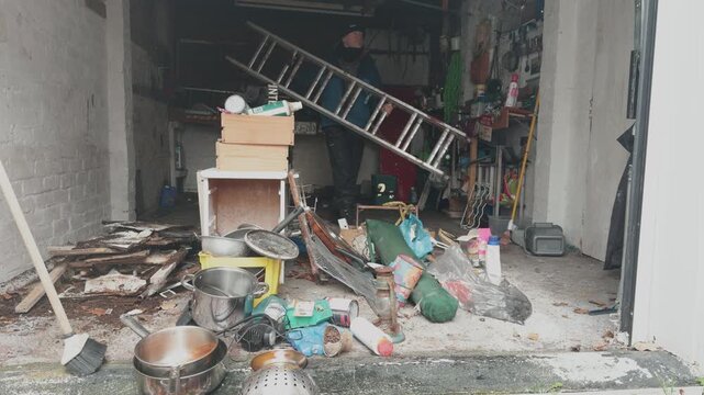 Household items and rubbish gathered in a garage during a clearance, ready for disposal at the tip, showing decluttering, cleanup and property cleanout work