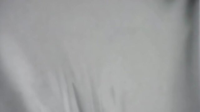 Abstract Textured Background. A soft, flowing fabric creates a minimalist backdrop, lending itself to a variety of applications.