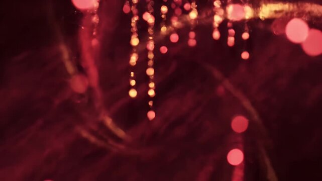 Abstract image of swirling, blurred red orbs on a dark background. Bokeh effect