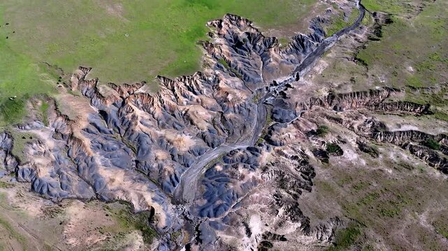 Abstract aerial view of heavy soil erosion as rainfall weathers away landscape