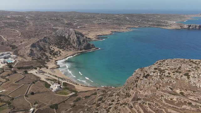 Stunning aerial footage revealing a beautiful secluded beach in karpathos with turquoise water in a rocky bay