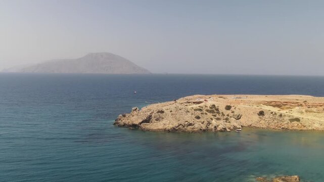 Aerial drone view of a rocky coast karpathos with kasos island view on a sunny day in the mediterranean sea