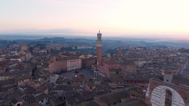 Aerial sunrise over Siena with Mangia Tower, Cathedral, Il Campo Square