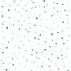 Obraz premium A scattered pattern of small, pale triangles in grey, teal, and peach tones on white