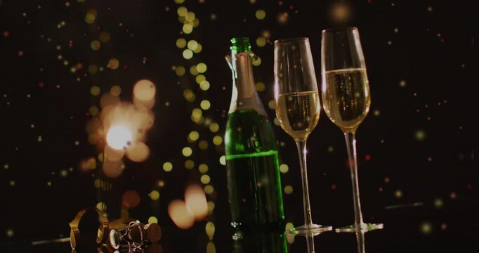 Vertical video: Green bottle and flutes resting, sparkles drifting causing bokeh pulsing for events
