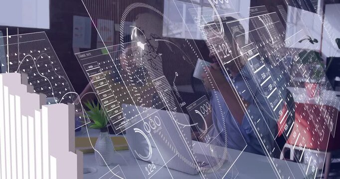 Man sipping mug while woman reaching keys at desk, causing data overlays guiding business analysis