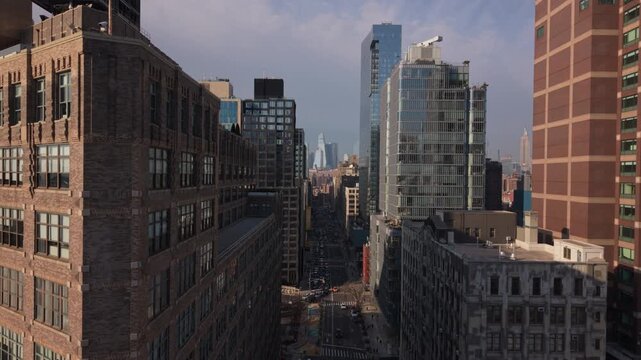NYC rising past American flag shot facing north view of 6th Ave.