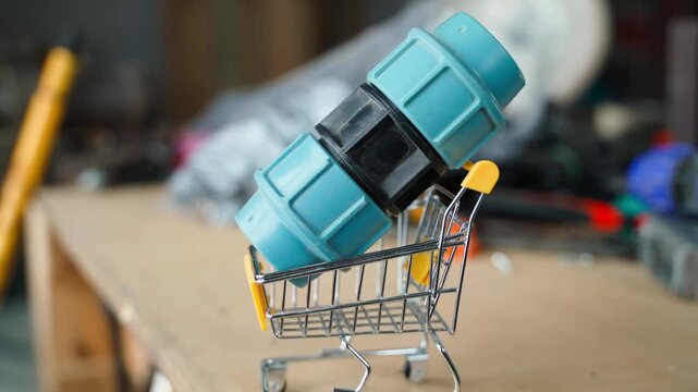 Placing garden water hose adapter into toy shopping cart close-up