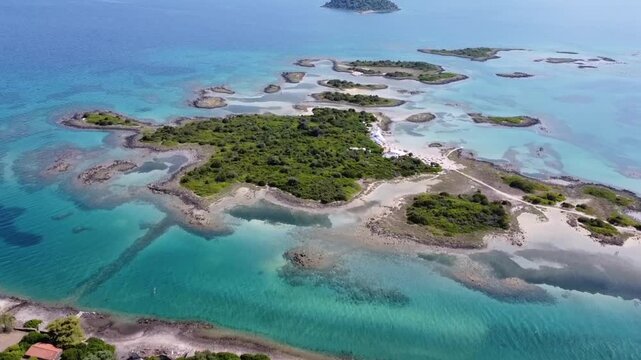 Cinematic high-angle drone panorama of the Lichadonisia islands. Stunning view of turquoise lagoons, volcanic islets and organized beach. The "Seychelles of Greece" in Evia. Ideal for travel films.