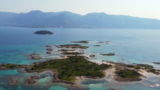 Cinematic drone shot of the Lichadonisia archipelago in Greece. High-angle view showing tropical turquoise waters and lush green islets. Perfect for travel and vacation visual storytelling.