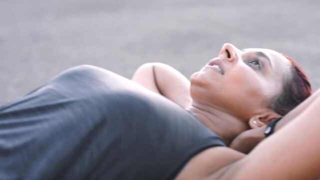 Fitness, sit ups and woman on street outdoor for core exercise, strength or training routine. Breathing, power and workout with person on ground in city for commitment or dedication to health