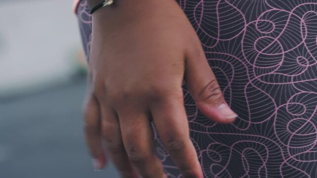 Fitness, hand and tension with person outdoor for commitment or dedication to cardio training. Exercise, fingers and nervous tick with worried runner in city for health, wellness or workout anxiety