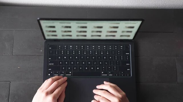 ノートパソコンをタイピングする手元 俯瞰 ビジネス リモートワーク 集中 / Close-up of hands typing on laptop keyboard, top view, remote work and productivity concept