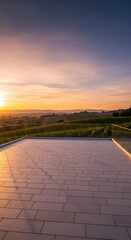 Fototapeta premium Beautiful sunset over rolling hills and vineyards with a modern patio in the foreground, creating a serene and luxurious outdoor living space.
