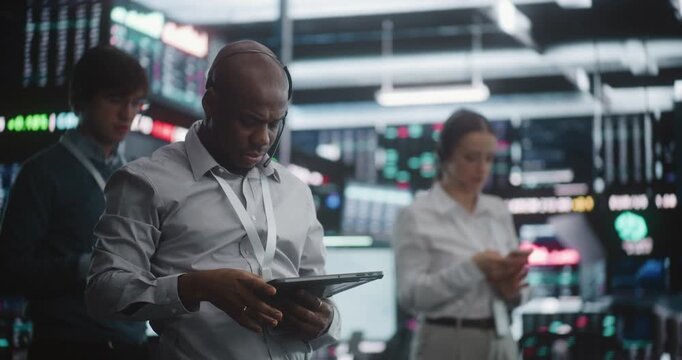 Multicultural Team of Professional Traders Standing in Active Trading Pit, Simultaneously Gesture, Shouts Orders, and Checks Their Tablets. Concept Synchronized Teamwork and Rapid Crisis Management.