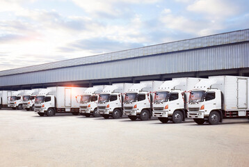 Row of Container Trucks on Loading Dock at Warehouse. Shipping Cargo Container. Trucks Loading...