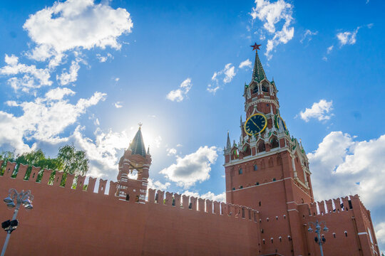 Moscow Kremlin landmark view &mdash; Spasskaya Towerwith iconic clock and red brick walls in Russia, symbol of national history, power and timekeeping tradition near Red Square.
