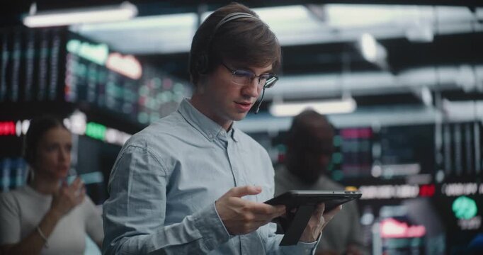 Male Financial Analyst in Blue Shirt Using Hand Gestures Execute Trades at Stock Market. Concept of Rapid Fire Decision Making Process Required in Professional Investment Banking and Asset Management.