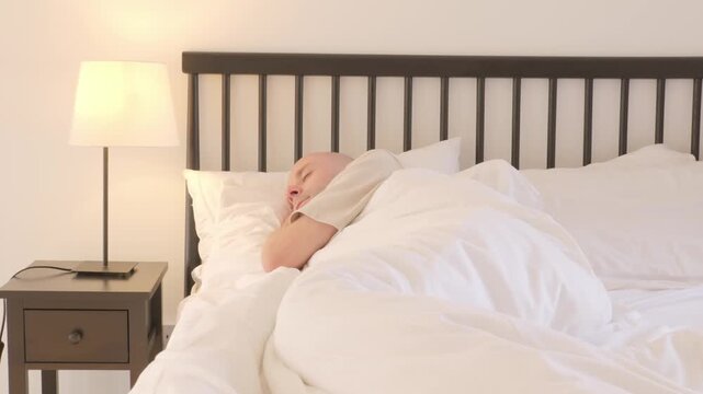 Young man sleeping peacefully in bed, health recovery, REM sleep, bedtime calm, adult male rest, recovery from daily stress and fatigue, physical recovery