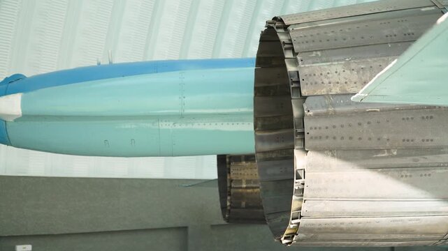 Fighter jet nozzle with many composite petals closeup in hangar. Afterburner exhaust opening on modern supersonic aircraft.