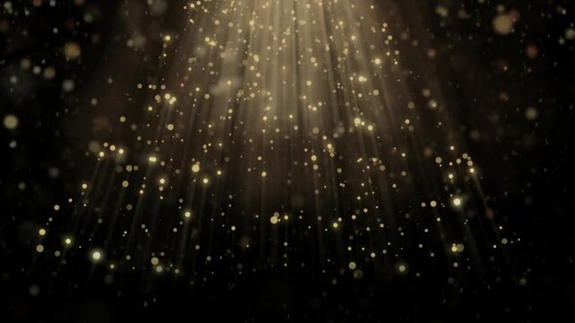 Glowing gold particles floating down with light rays on black background video footage