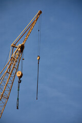 Naklejka premium The metal structure of a yellow industrial crane located in the port of Vigo for modern shipbuilding.
